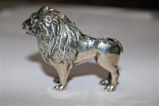 An Edwardian silver pincushion in the form of a standing lion (cushion and tail deficient),